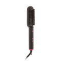 Brosse lissante noire vue de face sur fond blanc, picots en céramique, boutons roses et bague rose à la base du cordon